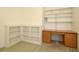 Carpeted home office with built-in shelves and desk in the corner at 9593 Se 124Th Loop, Summerfield, FL 34491