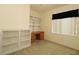 Carpeted home office with built-in shelves and desk near window at 9593 Se 124Th Loop, Summerfield, FL 34491