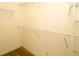Bright walk-in closet featuring carpeted flooring and metal shelving units at 9593 Se 124Th Loop, Summerfield, FL 34491