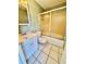 Bathroom with white tile flooring, vanity, and a shower with sliding doors at 10301 Us Highway 27 # 98, Clermont, FL 34711