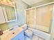Clean bathroom featuring tile flooring, white vanity, and tub with sliding glass doors at 10301 Us Highway 27 # 98, Clermont, FL 34711