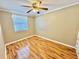 Bedroom featuring wood flooring, a window and a ceiling fan at 10301 Us Highway 27 # 98, Clermont, FL 34711