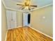 Bedroom with ceiling fan, closet and wood flooring at 10301 Us Highway 27 # 98, Clermont, FL 34711