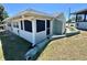 Charming exterior view of the home featuring well-maintained green siding and landscaping at 10301 Us Highway 27 # 98, Clermont, FL 34711