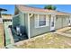 Home exterior showing green siding, white trim, and a well maintained air conditioning unit at 10301 Us Highway 27 # 98, Clermont, FL 34711