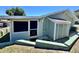 Rear exterior of the home, showcasing the storage room, door, and window at 10301 Us Highway 27 # 98, Clermont, FL 34711