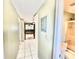 Bright hallway with tile flooring leads to a spacious living area and bathroom at 10301 Us Highway 27 # 98, Clermont, FL 34711