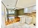 Bright kitchen featuring white cabinets, mosaic backsplash, and granite countertops at 10301 Us Highway 27 # 98, Clermont, FL 34711