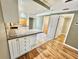 Cozy kitchen featuring white cabinets, granite countertops, and a tile backsplash at 10301 Us Highway 27 # 98, Clermont, FL 34711