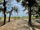 Scenic lake view framed by trees, offering a tranquil and picturesque outdoor space, seating and dock at 10301 Us Highway 27 # 98, Clermont, FL 34711