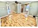 Inviting living room features laminate floors, fan, and sliding glass door to the sunroom at 10301 Us Highway 27 # 98, Clermont, FL 34711