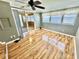 Well-lit living room boasts laminate floors, fan, multiple windows, and sunroom access at 10301 Us Highway 27 # 98, Clermont, FL 34711