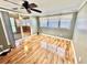 Bright living room featuring wood laminate flooring and sliding glass doors to the sunroom at 10301 Us Highway 27 # 98, Clermont, FL 34711