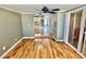 Comfortable living area showcasing hardwood floors, fan, and entrance to kitchen at 10301 Us Highway 27 # 98, Clermont, FL 34711