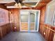 Enclosed sunroom with wood-paneled walls, neutral carpet, and a ceiling fan with a light fixture at 10301 Us Highway 27 # 98, Clermont, FL 34711