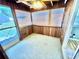 View of the sunroom featuring wood paneled walls, carpet flooring, and multiple windows at 10301 Us Highway 27 # 98, Clermont, FL 34711