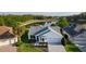 Aerial view of a charming home with a lake view and well-manicured lawn at 1142 Salido Ave, The Villages, FL 32159