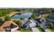 An aerial view of the property showcasing a landscaped yard, lake view and a well-manicured lawn at 1142 Salido Ave, The Villages, FL 32159