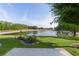 Large backyard with well-maintained lawn and tranquil lake views, providing a serene outdoor setting at 1142 Salido Ave, The Villages, FL 32159