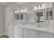 Bright bathroom featuring a double sink vanity with white cabinets and framed mirrors at 1142 Salido Ave, The Villages, FL 32159