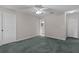 Neutral bedroom with overhead fan, view into attached bath, and closet at 1142 Salido Ave, The Villages, FL 32159