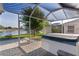 View of the enclosed back patio that has a hot tub and overlooks the beautiful lake at 1142 Salido Ave, The Villages, FL 32159