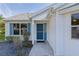 Charming home entrance with a vibrant blue front door and beautifully landscaped walkway at 1142 Salido Ave, The Villages, FL 32159