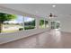 Sunroom featuring tile floors and large windows with a view of the lake at 1142 Salido Ave, The Villages, FL 32159