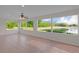 Bright sunroom with tile floors and large windows overlooking a serene pond view at 1142 Salido Ave, The Villages, FL 32159
