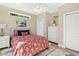 Comfortable bedroom features a vibrant floral bedspread and white dresser at 12129 Grand Oak Ln, Oxford, FL 34484