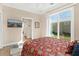 This bedroom has an exterior view and mounted television at 12129 Grand Oak Ln, Oxford, FL 34484