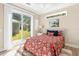 Bedroom showcasing bed with a large sliding glass door and bright natural light at 12129 Grand Oak Ln, Oxford, FL 34484