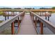 Picturesque fishing pier with viewing platforms and comfortable seating, perfect for enjoying serene water views and leisurely fishing at 12129 Grand Oak Ln, Oxford, FL 34484