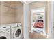 Convenient laundry room with shelving and adjacent bedroom access at 12129 Grand Oak Ln, Oxford, FL 34484