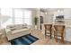 Cozy living room nook features a comfortable sofa, natural light, and an eat-in kitchen island at 12129 Grand Oak Ln, Oxford, FL 34484