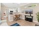 Bright living room with wood floors, kitchen bar seating, and modern decor for a welcoming space at 12129 Grand Oak Ln, Oxford, FL 34484