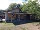 Covered backyard area with a wooden structure, providing ample outdoor storage space and potential for customization at 1431 Ne 53Rd St, Ocala, FL 34479