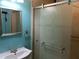 Bathroom showcasing a sink with mirror and shower with sliding doors and an attractive etched design at 1431 Ne 53Rd St, Ocala, FL 34479