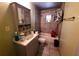 This cozy bathroom features tiled walls, built-in shelving, and a shower-tub combo with a curtain at 1431 Ne 53Rd St, Ocala, FL 34479