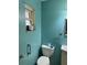 Bathroom featuring a toilet, sink, and a small window for natural light at 1431 Ne 53Rd St, Ocala, FL 34479