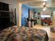 Bedroom with a colorful quilt, furniture, and personal items in need of organizing at 1431 Ne 53Rd St, Ocala, FL 34479