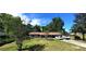 Charming single-story home with a well-maintained lawn, mature trees, and a private driveway, offering a serene and welcoming atmosphere at 1431 Ne 53Rd St, Ocala, FL 34479