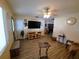 Cozy living room with wood-look flooring, TV, and ceiling fan at 1431 Ne 53Rd St, Ocala, FL 34479