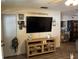 Living room featuring a large TV, wood-look flooring, and wall decor at 1431 Ne 53Rd St, Ocala, FL 34479