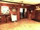 Spacious room featuring wood paneled walls, tile flooring, and bar-style lighting at 1431 Ne 53Rd St, Ocala, FL 34479