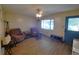 Inviting living room with two armchairs, wood flooring, and a window view at 1431 Ne 53Rd St, Ocala, FL 34479
