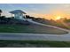 Charming structure featuring a green exterior, under a captivating sunset sky at 1606 Mount Croghan Trl, The Villages, FL 32162