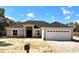 Charming single-story home featuring a two-car garage, neutral paint, stone accents, and a well-manicured yard at 16374 Se 88Th Ave, Summerfield, FL 34491