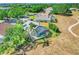Aerial view of home showcasing screened-in pool, landscaped yard, and neighborhood at 16538 Rockwell Heights Ln, Clermont, FL 34711