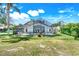 View of the screened-in backyard with pool, waterfall feature, patio, and sliding glass doors at 16538 Rockwell Heights Ln, Clermont, FL 34711
